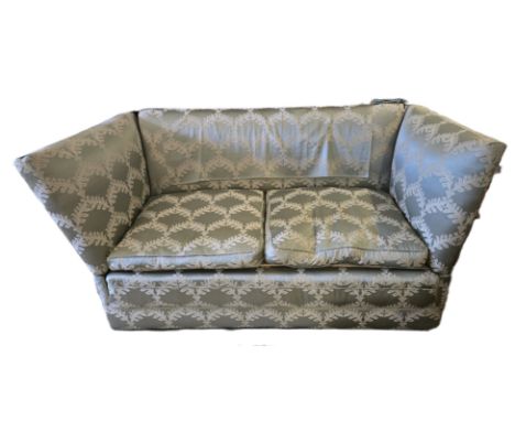 An English Knoll two seater sofa in pale green damask.Rope and tassel wrapped around decorative wood finials. With hinged sid