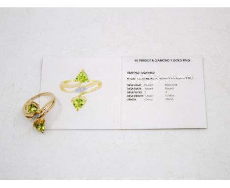 9ct Gold Peridot and Diamond Ring  The ring contains two Trilliant Cut Peridots. Total Carat Weight of the Peridot is: 1.33ct