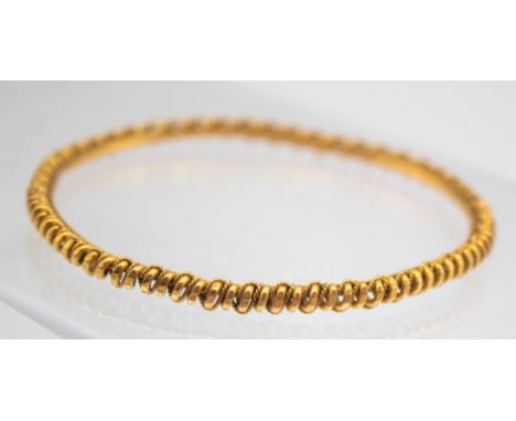 21ct Gold Twisted Design Bangle The Bangle is hallmarked "21ct" for 21ct Gold. Total Gross Weight of the Bangle is approx. 17