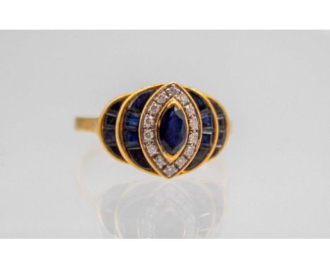 18ct Gold Sapphire and Diamond Dress Ring The Ring contains a Marquise shaped Sapphire in the Centre that measures approx. 5.
