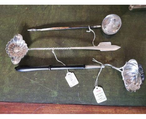 A Georgian white metal toddy ladle, the bowl is engraved with berries and leaves. 29cm long. A Georgian silver double spouted