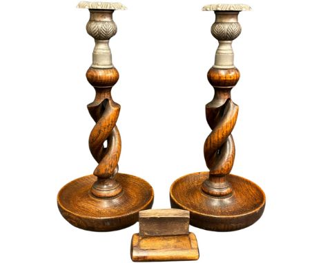 A pair of early 20th century oak open barleytwist candlesticks with metal mounts, 24.5cm high and a 19th century wood snuff b