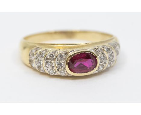 "585" stamped Gold Synthetic Ruby and Cubic Zirconia Dress Ring  The ring is hallmarked "585". The ring contains an Oval Bril