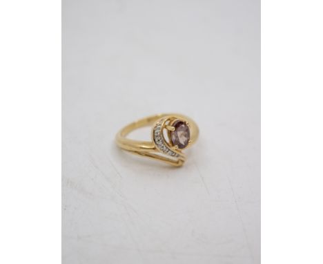 9ct Gold Colour-Change Garnet and Diamond Ring  The ring contains a 0.598ct Oval Brilliant Cut Colour-Change Garnet that chan