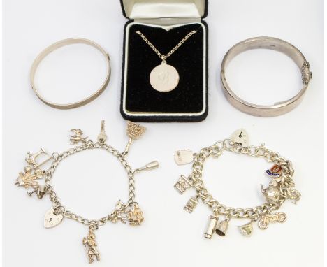 A selection of Sterling Silver Jewellery. To include two Vintage Silver Hinged Bangles, two Silver Charm Bracelets and a Unma