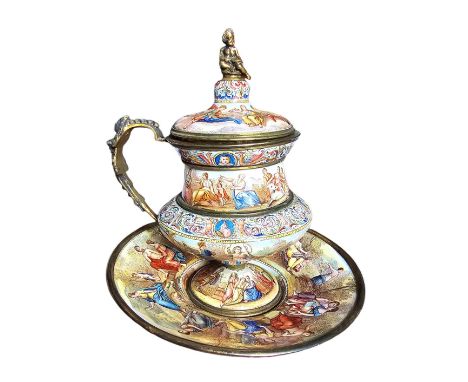 A late 19th century Austrian silver gilt and enamel lidded ewer and stand.The lidded ewer of classical form with lobed lower 