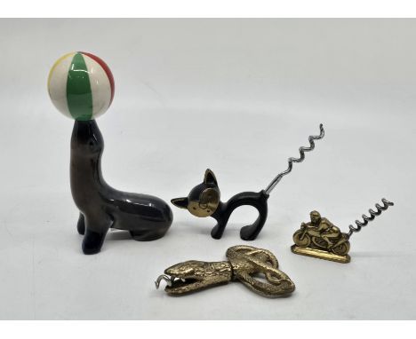 A collection of four novelty corkscrews, to include -  A Wade ceramic Seal figurine with ball corkscrew. A 1950s Walter Bosse