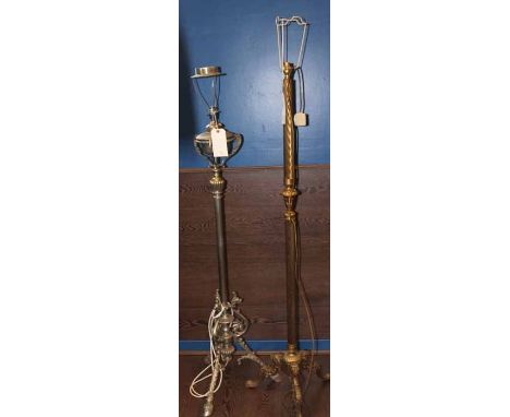 TWO CAST METAL STANDARD LAMPS
the larger in brass with twist pole and three claw feet, the smaller with oil burner styled lig