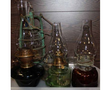 SIX VINTAGE OIL AND PARAFFIN LAMPS
most with glass bases, some with handles; together with a metal gas lamp two other globe g