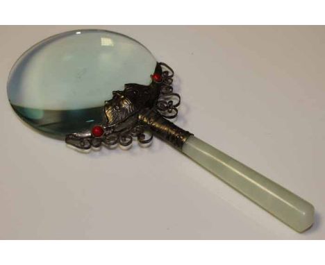 CHINESE STYLE MAGNIFYING GLASS
len held in a white metal and red stone setting with a celadon coloured stone handle (possibly