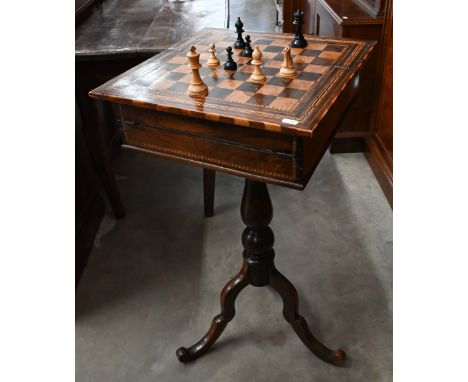 An Edwardian marquetry games/sewing table with chess board inlaid top enclosing fitted interior on tripod base, 40 x 40 x 77 