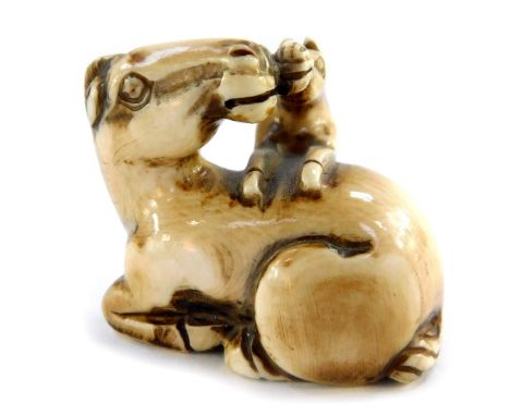 A Japanese late Taisho / early Showa  period stained ivory netsuke, carved as two horses, signed, 37mm wide. 