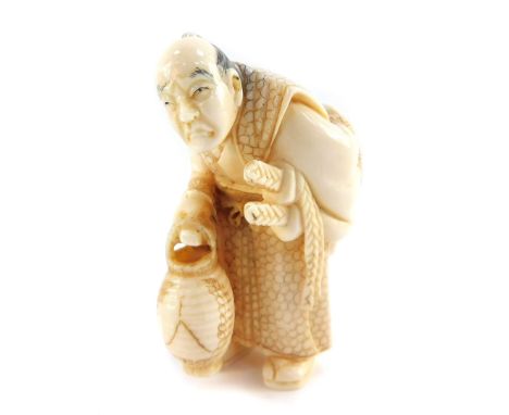 A Japanese Taisho period ivory figure carved as an old Samurai warrior, with a lantern, unsigned, 47mm high.