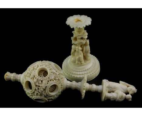 A Chinese Qing dynasty ivory puzzle ball, carved to the outer ball with figures and pagodas, with a double figure finial, and