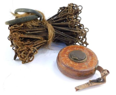 A Treble vintage leather cased tape measure, together with a surveyor's vintage land measuring chain. (2)