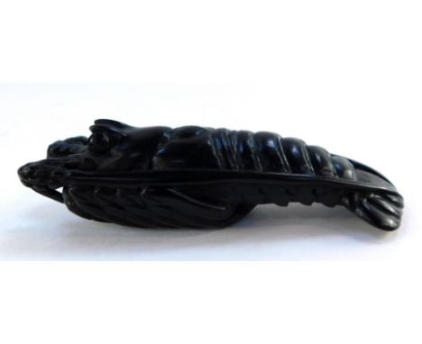 A Japanese late Taisho / early Showa  period wooden netsuke, possibly ebony, carved as a crayfish, inlaid signature,  72mm wi