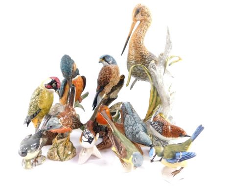 A group of Mack porcelain figures of birds, comprising green woodpecker., nuthatch., wren., black tailed godwit., kestrel and