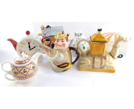 A group of character teapots, comprising a Tony Wood camel teapot., Angler teapot., Arthur Wood Cream Tea teapot., clock face