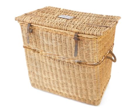 An early 20thC bamboo and cane dog basket, the hinged lid bearing an enamel plaque "Live Dog, With Care", with leather straps