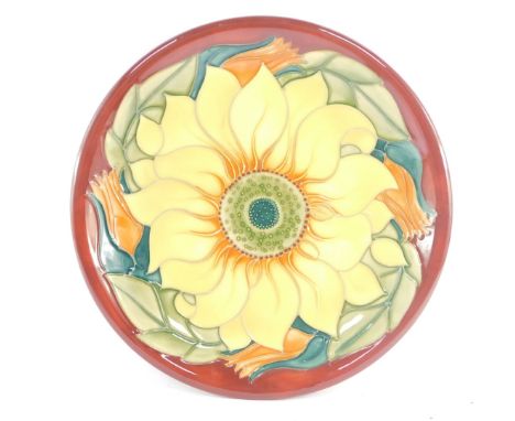 A Moorcroft pottery plate decorated in the Inca Sunflower pattern, painted and impressed marks, 26cm diameter.