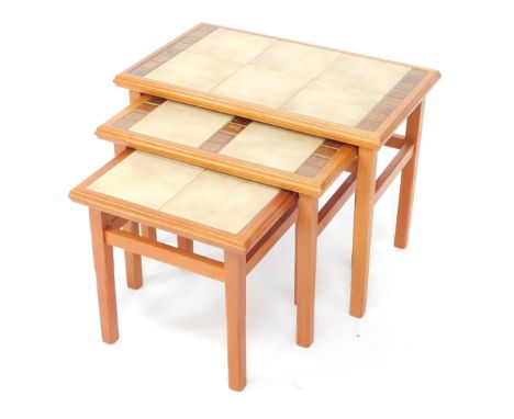 A nest of mid century teak and tile top occasional tables, largest 43cm high, 57cm wide, 34cm deep.