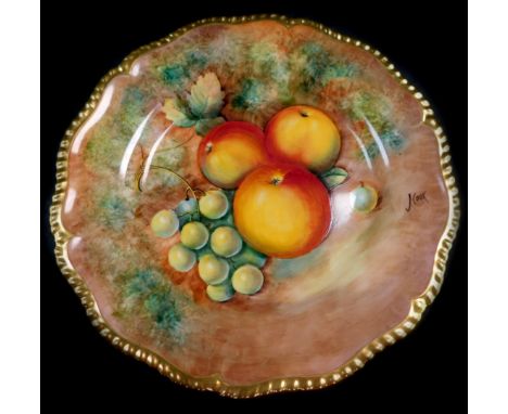 A Royal Worcester porcelain cabinet plate, signed J Cook, painted with apples and green grapes, 25cm diameter.
