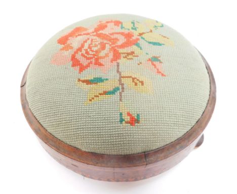A Victorian walnut and inlaid foot stool, with floral wool work tapestry, raised on three bun feet, 27cm diameter.
