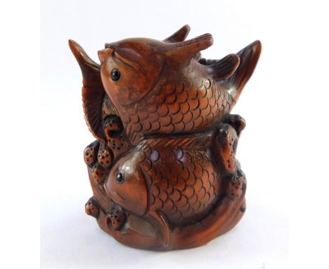 A Japanese late Taisho / early Showa  period wooden netsuke carved as three Shubunkin, signed,  42mm high.