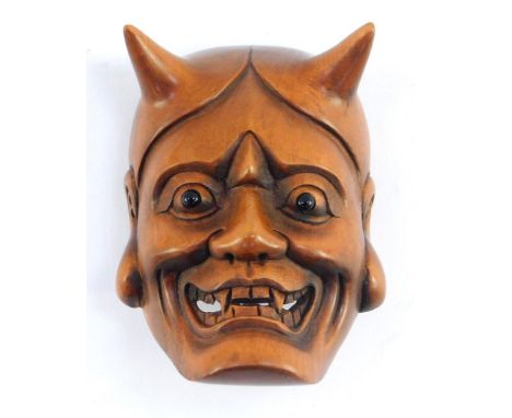 A Japanese late Taisho / early Showa  period wooden netsuke carved as a Noh mask of Hannya, the jealous female demon, signed,