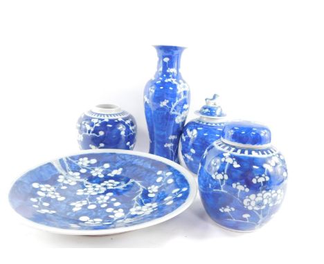 A group of Qing dynasty blue and white porcelain, decorated with prunus blossom against a cracked ice ground, composing, a ba