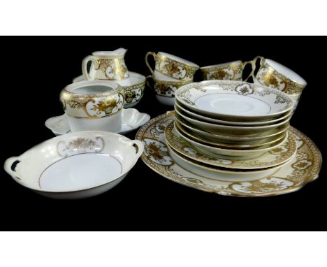 A Noritake porcelain part tea service, decorated in gilt with reserves of baskets of flowers and further flowers, against a c