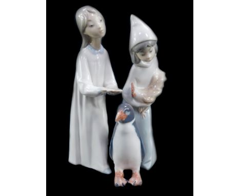 A Royal Copenhagen porcelain figure modelled as a penguin, no 1283., printed and painted marks, together with a Lladro porcel