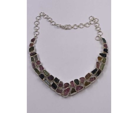 A tourmaline multi-stone necklace collar set in silver, the chain with an adjustable length. Unhallmarked, assessed as silver
