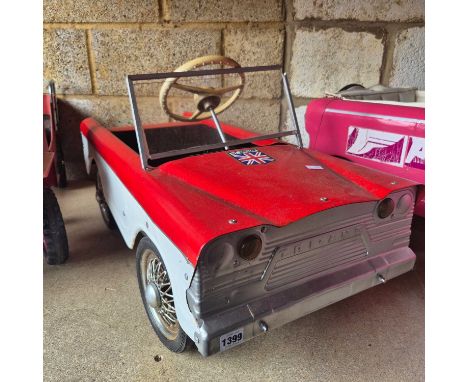 A Tri-Ang tinplate pedal car of 1960's american styling.