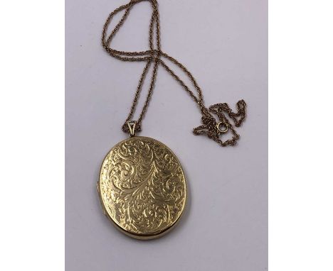 A vintage 9ct hallmarked gold large oval portrait locket 5.8 x 3.9 cm, suspended on an unhallmarked gold chain, assessed as 9