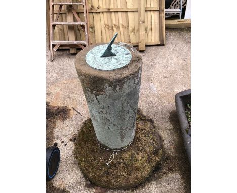 A patinated bronze sundial mounted on antique sandstone circular column support.