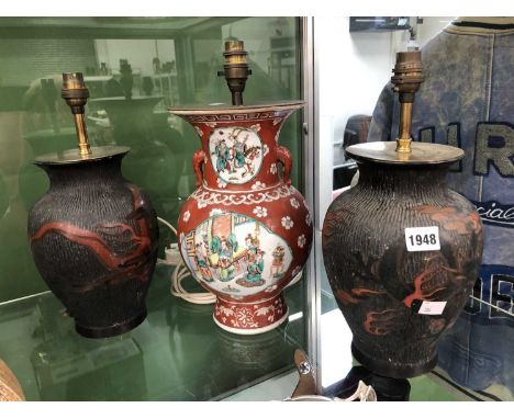 A pair of Japanese lacquer vases as lamps together with a Chinese red ground porcelain vase as a lamp