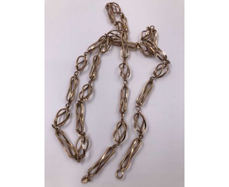 A 9ct hallmarked gold fancy link open-work chain. Weight 31.76 grams. 