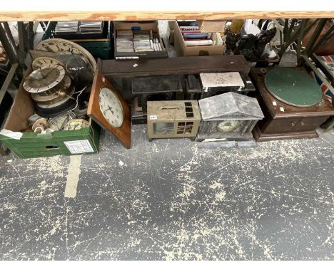 A collection of clocks and their parts, G-clamps, a barograph and a wind up gramophone