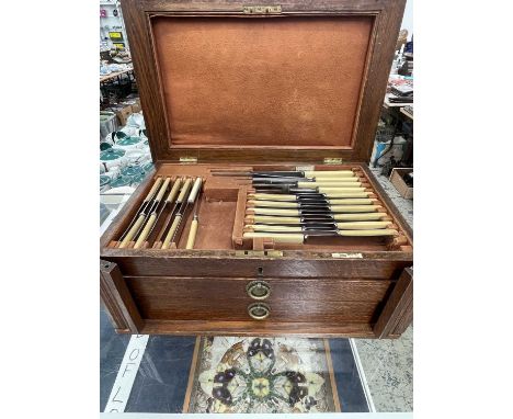 An oak canteen of Walker and Hall electroplate Old English pattern cutlery