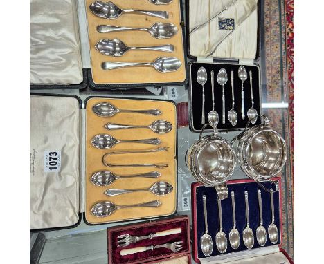 Various hallmarked silver tea and coffee spoon sets, grapefruit spoons, a silver creamer and matching sugar basin, and a pair