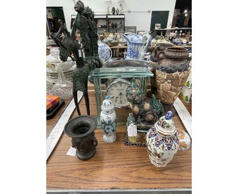 A pair of Bretby vases, a glass cased clock, an African bronze group of three men on a horse, a Kutano dog of fo, a Japanese 