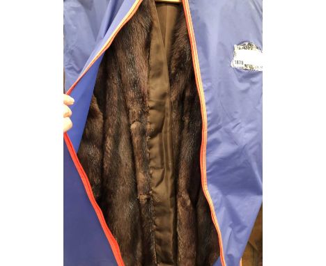 A long mink fur coat and a leather vintage clutch bag