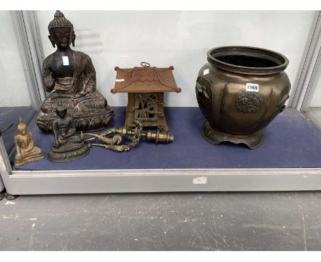 A bronze figure of the Buddha, two smaller, an iron lanterns, a Japanese bronze planter and a table lamp
