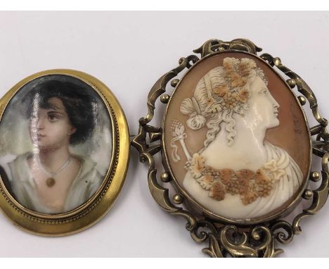 A porcelain and gold portrait brooch, unhallmarked, stamped JM, assessed as 15ct gold, together with a large portrait cameo b