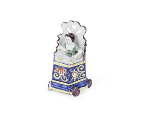 Figurine d'une jeune fille assise sur une chaise haute en faience de Delft, Pays-Bas, vers 1750-70 A Dutch Delft figure of a 
