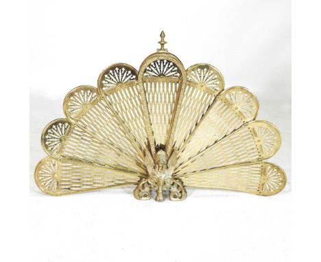An early 20th century brass folding fire screen, of folding peacock design, 62cm high
