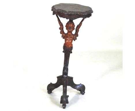 A 19th century Italian carved fruitwood occasional table, with a shaped top, on a winged cherub figural support and scrolled 