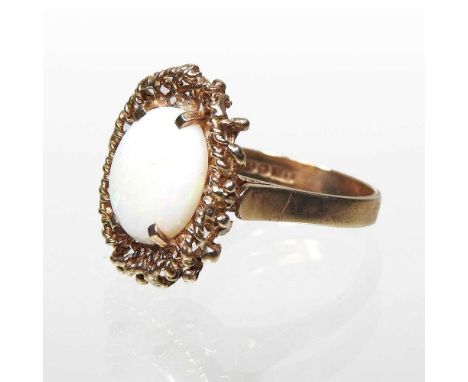 A 9 carat gold ring, set with a central oval opal, within a ropetwist surround, 4.5g, size N, 20 x 15mm