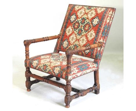 A large late 17th century walnut throne chair, with an upholstered seat and back, on ring turned legs, 68cm wideSolid and usa